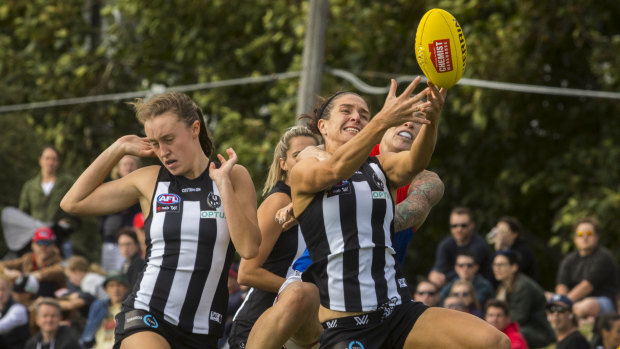 Collingwood players desperately try to contain an inform Melbourne at Victoria Park.