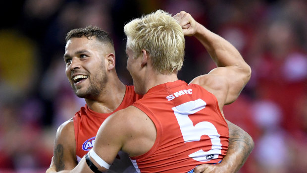 Narrow margins: Lance Franklin celebrates a goal with Isaac Heeney in a tight contest at Etihad Stadium.