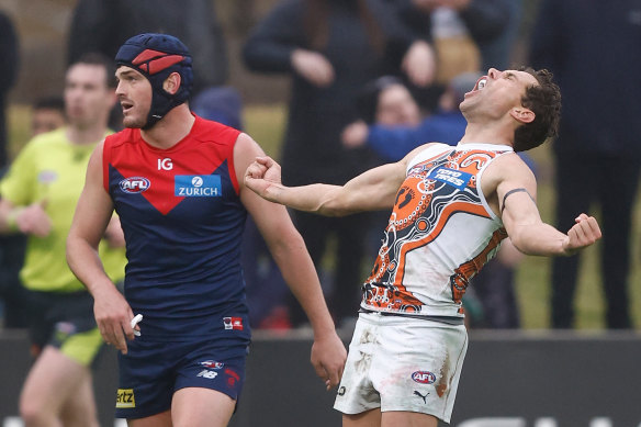 The Giants’ Josh Kelly celebrates and Melbourne’s Angus Brayshaw laments in Alice Springs on Sunday.