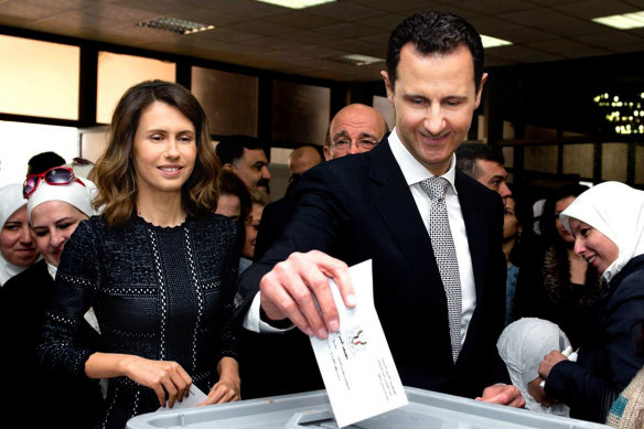 Syrian President Bashar al-Assad, pictured casting his ballot in parliamentary elections in 2016, as his wife Asma, left, looks on.