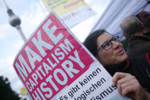 A protester holds a poster during a trade union demonstration against budget cuts, in Berlin.