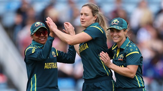 Ellyse Perry (centre) celebrates with captain Sophie Molineux (right) and Alana King after taking wicket against Bangladesh.