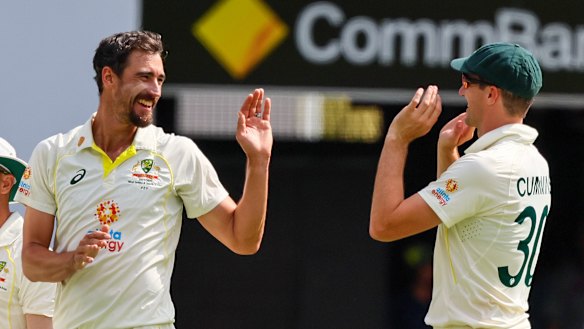 Pat Cummins congratulates Mitchell Starc.