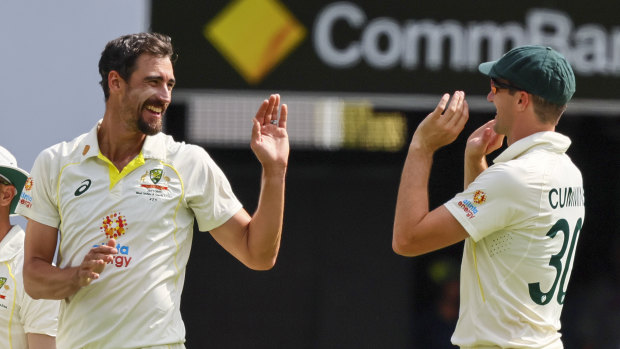 Pat Cummins congratulates Mitchell Starc.