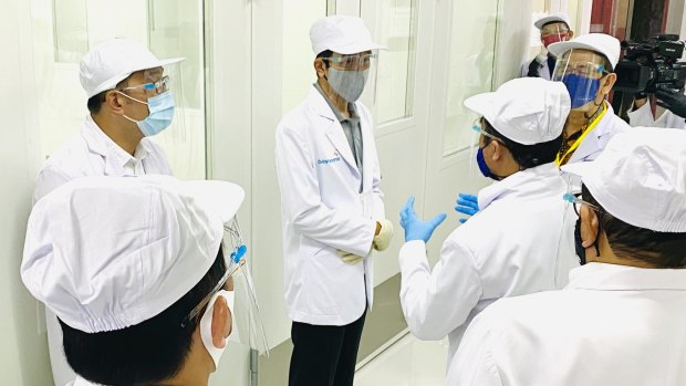 Will it work? Indonesian President Joko Widodo, centre, on Tuesday at the site of phase three clinical trial for the SinoVac vaccine.