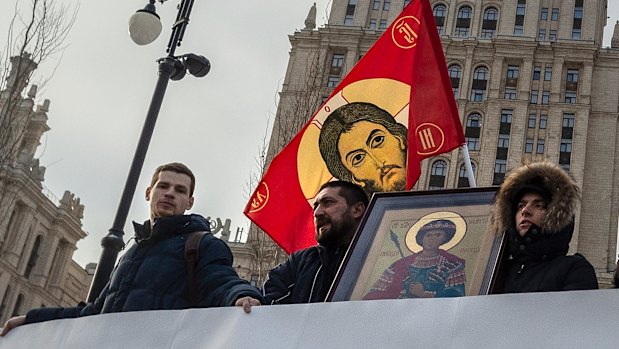 Russian Orthodox Church activists stand in front of the  Ukraine hotel in Moscow in a picket to protest the church meeting in Kiev.