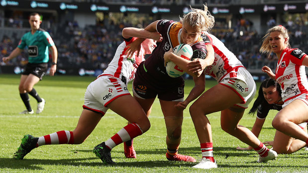 Meg Ward busts through to score for the Broncos in their NRLW opener against the Dragons. 
