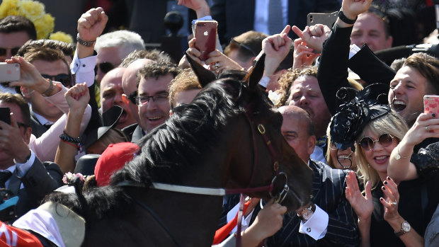 Popular winner: Extra Brut is hailed by an appreciative crowd after winning the Victoria Derby.