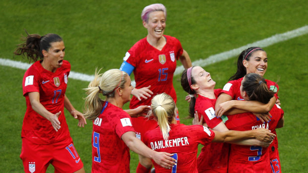 Getting on with business: United States' Alex Morgan, right, celebrates with her teammates after scoring against Thailand at the Stade Auguste-Delaune in Reims.