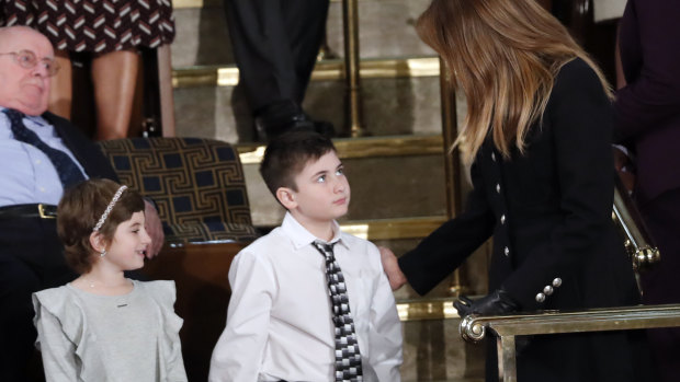 Guests Grace Eline and Joshua Trump, greet first lady Melania Trump before Donald Trump delivered his speech. 