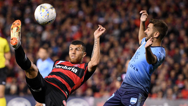 High on confidence: Jaushua Sotirio challenges Michael Zullo for the ball in the first of the two Sydney derbies so far this season.