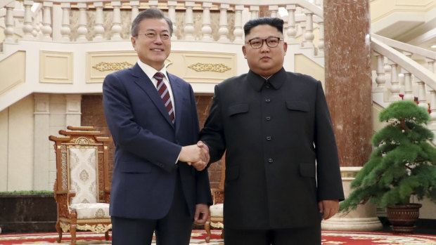 South Korean President Moon Jae-in, left, and North Koran leader Kim Jong-un stand at the headquarters of the Central Committee of the Workers' Party in Pyongyang, North Korea. 