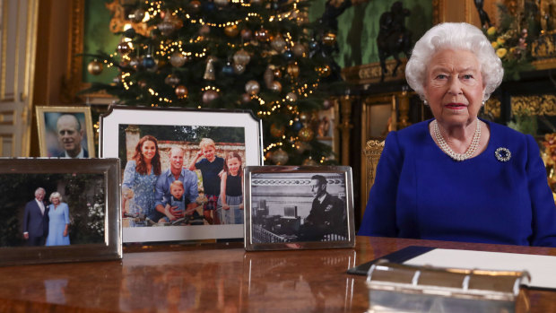 The photo used in the Duke and Duchess of Cambridge's Christmas card being displayed on the desk used by the Queen for the recording her annual Christmas Day message.