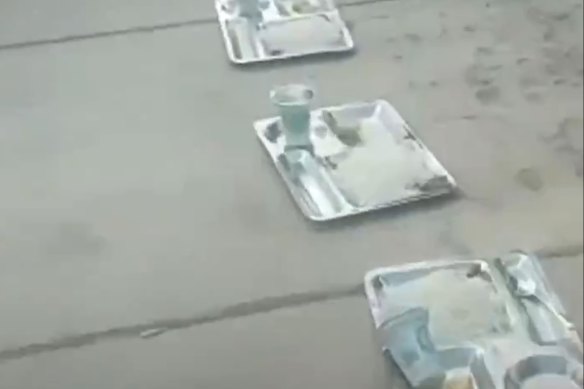 Canteen trays form a long line on the pavement outside Isfahan University of Technology in Isfahan, Iran. 