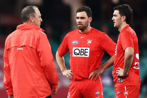 Paddy (centre) and Tom McCartin talk with coach John Longmire.
