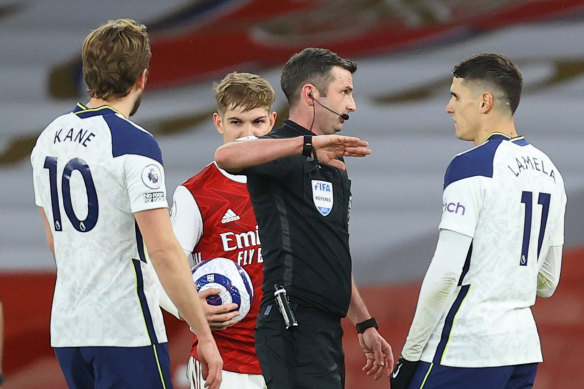 Erik Lamela gets his marching orders from referee Michael Oliver.