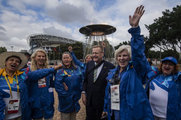AOC President John Coates in 2020 with volunteers at the Lighting of the Cauldron, celebrating the 20-year anniversary of the opening of the Sydney 2000 Olympic and Paralympic Games.
