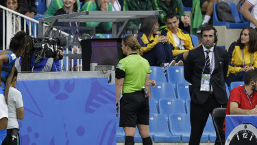 Swiss referee Esther Staubli checks the VAR monitor before awarding Australia's winning goal.