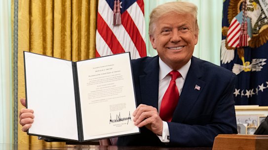 President Donald Trump smiles after signing a full pardon for a non-violent drug offence last year. 