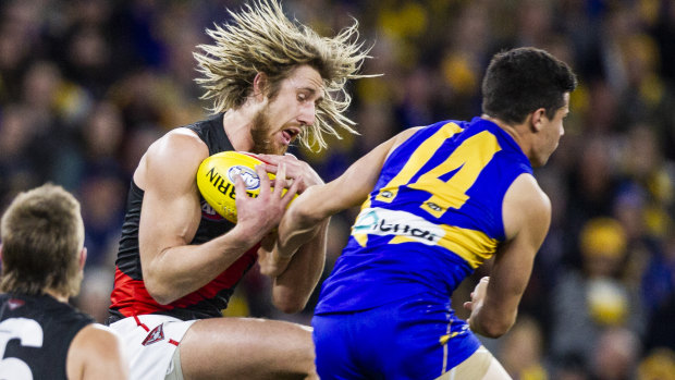 Hair-raising action: Essendon skipper Dyson Heppell takes a grab against West Coast in round 14.