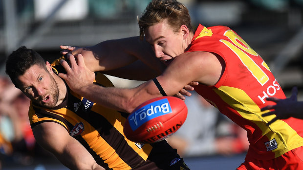 James Frawley of the Hawks (left) and Tom Lynch battle for the ball.