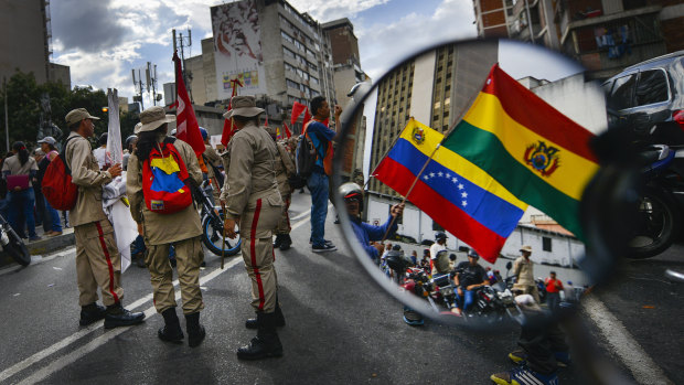 Supporters of Venezuelan President Nicolas Maduro rally in support of Evo Morales in Caracas.