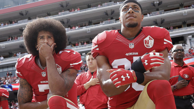 Colin Kaepernick and Eric Reid kneel during the national anthem in October 2016.