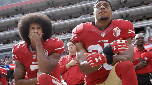 Colin Kaepernick and Eric Reid kneel during the national anthem in October 2016.