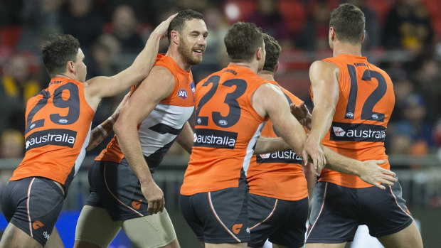 Shane Mumford after booting a goal for the Giants last year.