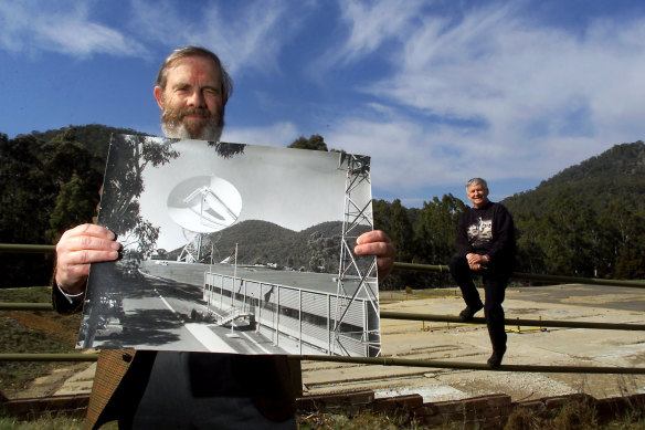 Hamish Lindsay (left) holding one of his own photographs of the former Honeysuckle Creek Tracking Station. Lindsay and John Saxon (right)  worked at the station on the night in 1969 that man first set foot on the moon.