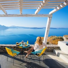 Woman enjoying breakfast with beautiful view over Santorini
iStock image for Traveller. Reuse permitted.
Greek breakfast, in Greece (Greek Islands)