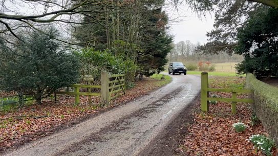 A car moves out of the Royal estate in Sandringham.