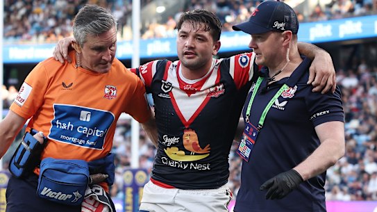 Brandon Smith is assisted from the field.