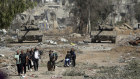 Palestinians flee from northern Gaza as Israeli tanks block the Salah al-Din road in the central Gaza Strip .