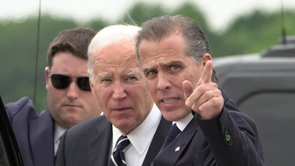 President Joe Biden talks with his son Hunter Biden as he arrives at Delaware Air National Guard Base.