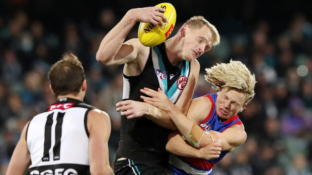 Cody Weightman came off second best from this clash with Port big man Sam Hayes.