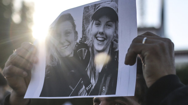 Pictures of Maren Ueland and Louisa Vesterager Jespersen are displayed during a candlelight vigil outside the Norwegian embassy in Rabat.