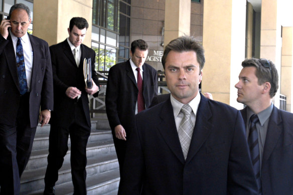 Then-Senior Sergeant Stuart Bateson leads members of the Purana taskforce away from Melbourne Magistrates Court in 2003.