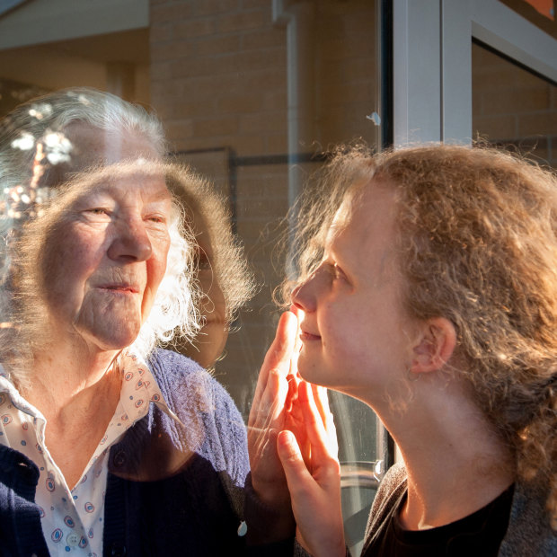 Grandmother Margaret Wheeler greets her granddaughter Alice Sarah-Lay through the glass at the Trentham Aged Care Facility. It's one of hundreds of images that make up Ballarat Foto's Mass Isolation project.