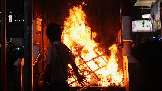 The entrance to a subway station is set on fire during a protest in Hong Kong on Sunday.