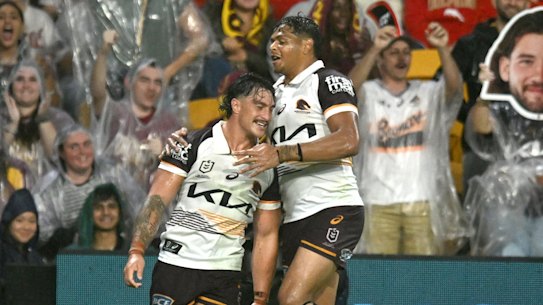 Kotoni Staggs and Selwyn Cobbo celebrate the former’s try for the Brisbane Broncos against the Dolphins.