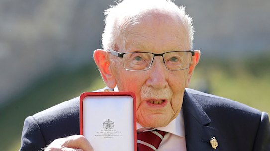 Captain Sir Thomas Moore poses for the media after receiving his knighthood.