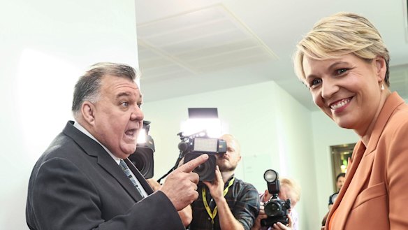 Craig Kelly and Tanya Plibersek argue in the hallway of Parliament House on Wednesday.