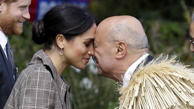 Meghan, Duchess of Sussex receives a "hongi" a traditional Maori welcome on the lawns of Government House in Wellington, New Zealand in 2018. 
