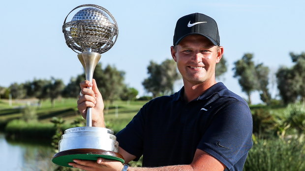Poise: England's Tom Lewis poses with the trophy after winning the Portugal Masters.