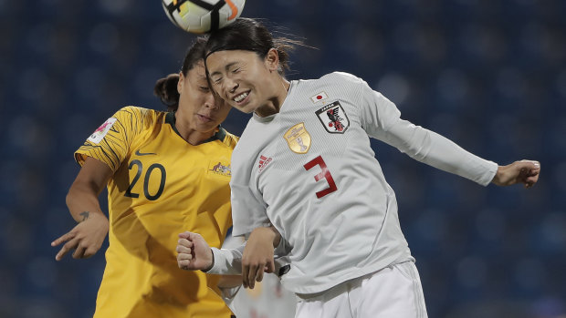 Japan's Aya Sameshima fights for control of the ball against Australia's Samantha Kerr.