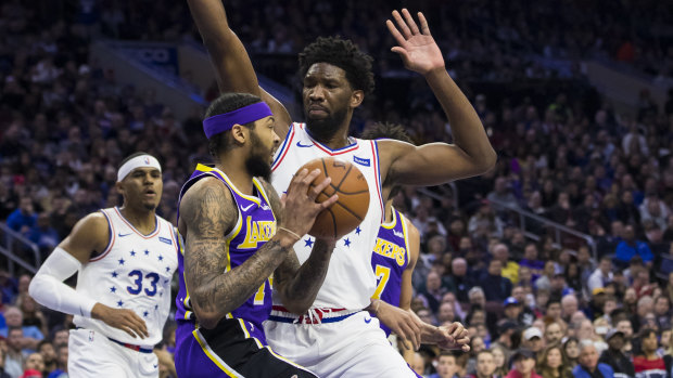 The Lakers' Brandon Ingram (left) is confronted by the 76ers' Joel Embiid.