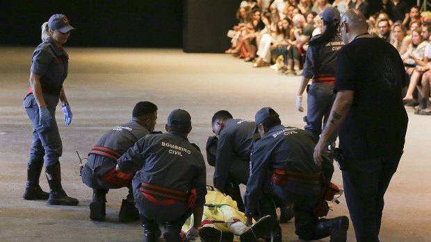 Paramedics rush to the aid of model Tales Soares after he collapsed during Sao Paulo Fashion Week.