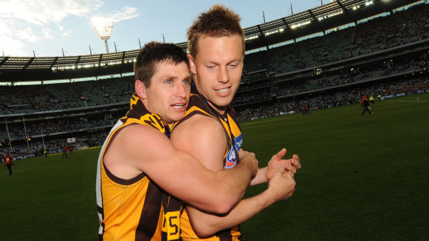 Shane Crawford and Sam Mitchell after Hawthorn’s famous 2008 premiership win.