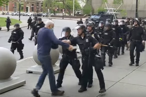 In this image from video provided by WBFO, a Buffalo police officer appears to shove a man who walked up to police on Thursday, June 4, in Buffalo, NY. 